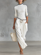 Women's matching activewear set with half-high-neck top and drawstring wide-leg pants, front view