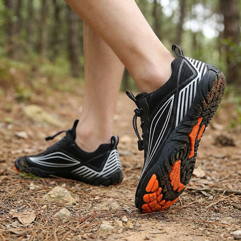Person wearing five-toe waterproof barefoot shoes walking on an outdoor trail